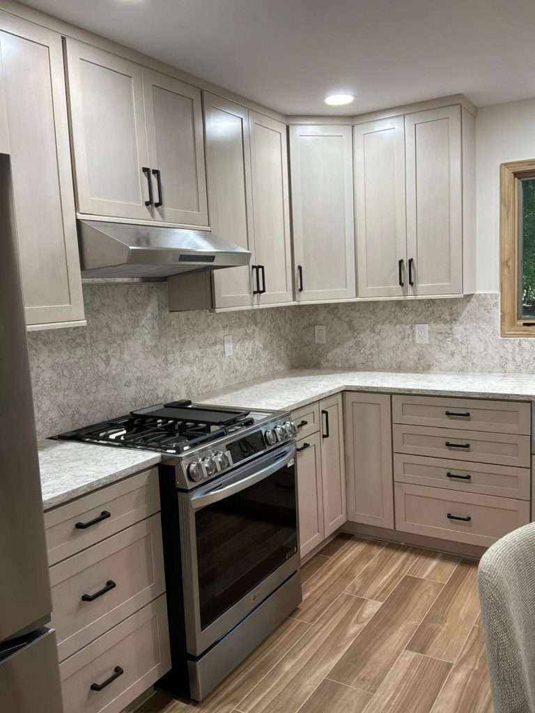 Kitchen with gas range and tile backsplash by Nuvista Designs General Contractors in Bergen County, NJ