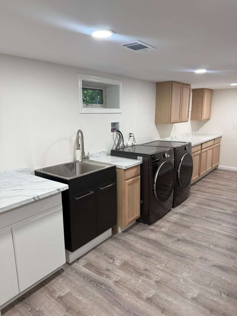 Finished basement with laundry area by Nuvista Designs General Contractors in Bergen County, NJ