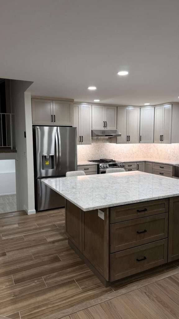 Kitchen remodel with island and stainless refrigerator by Nuvista Designs General Contractors in Bergen County, NJ