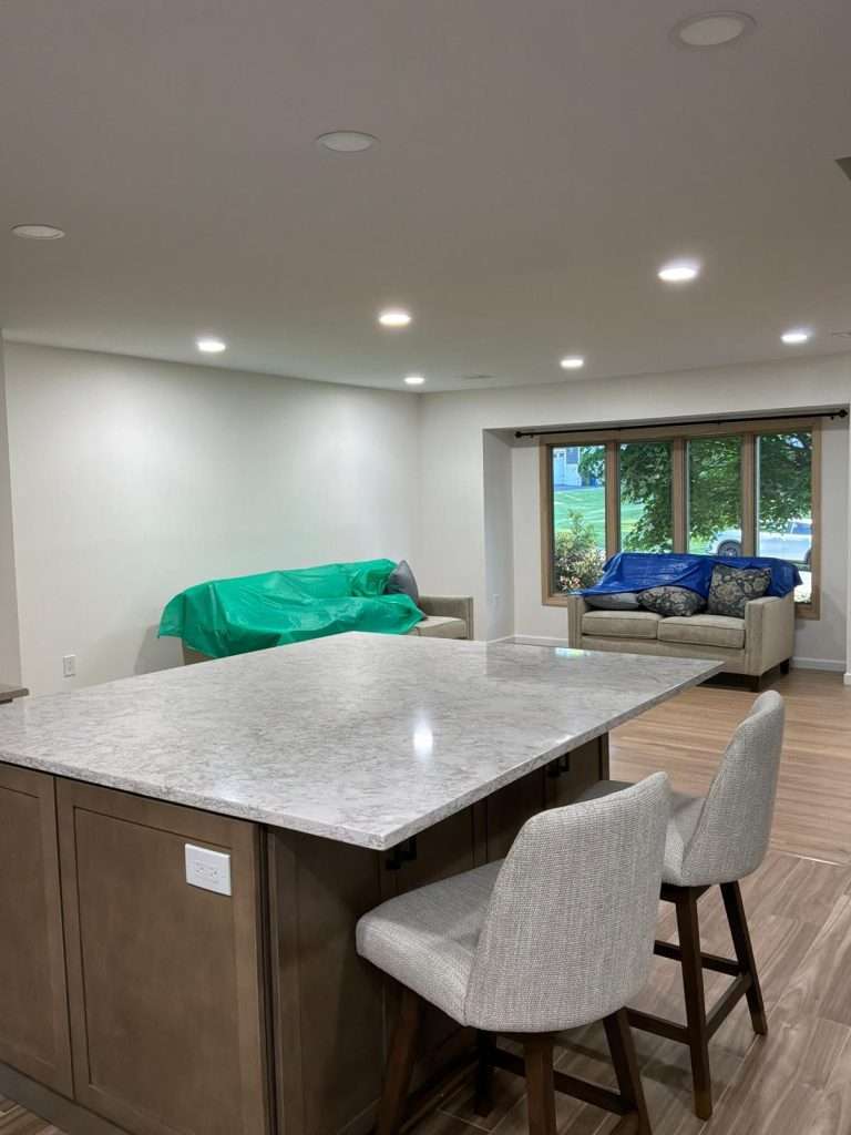 Open-concept kitchen with island seating by Nuvista Designs General Contractors in Bergen County, NJ